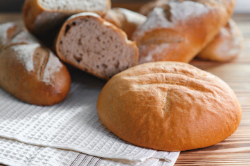Freshly baked sourdough bread with a golden crust on bakery shelves. Baker shop context with delicious bread