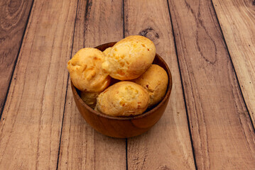 Brazilian-style cheese bread roll in a wooden bowl
