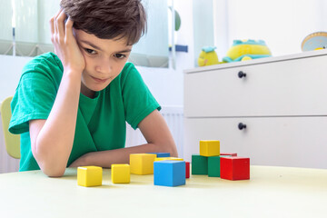 Child Engaging with Colorful Blocks During Therapeutic Session. Child therapy for learning...
