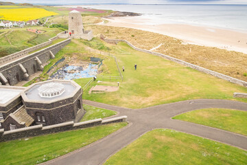 In the grounds of Bamburgh Castle with Bamburgh beach in the background, Northumberland, England, UK (May 2017)