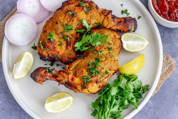 Grilled Chicken Legs with Onion Rings and Lemon Top Down Close-Up Healthy Food Photo