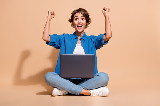 Full body size photo of young lady python developer software engineer fists up with netbook code works isolated on beige color background