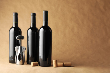 Bottles of wine, corks and wing corkscrew on parchment paper, space for text