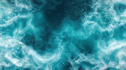 Fototapeta premium An aerial view of colorful, swirling ocean waves in a rich gradient of teal and deep blue. Ideal for a natural-themed project.