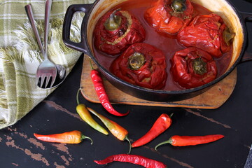 Stuffed bell peppers with meat and rice in tomato sauce, and spicy seasoning. homemade vegetarian dinner - baked colorful paprika stuffed with rice