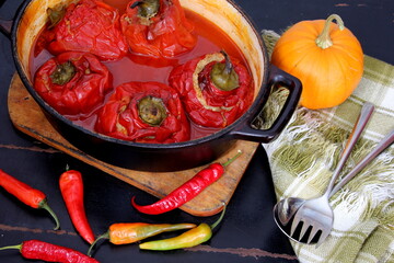 Stuffed bell peppers with meat and rice in tomato sauce, and spicy seasoning. homemade vegetarian dinner - baked colorful paprika stuffed with rice