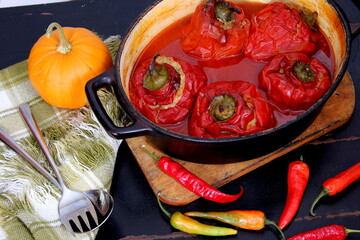 Stuffed bell peppers with meat and rice in tomato sauce, and spicy seasoning. homemade vegetarian dinner - baked colorful paprika stuffed with rice
