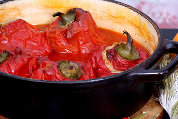 Stuffed bell peppers with meat and rice in tomato sauce, and spicy seasoning. homemade vegetarian dinner - baked colorful paprika stuffed with rice
