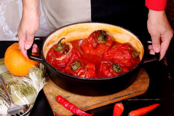 Stuffed bell peppers with meat and rice in tomato sauce, and spicy seasoning. homemade vegetarian dinner - baked colorful paprika stuffed with rice
