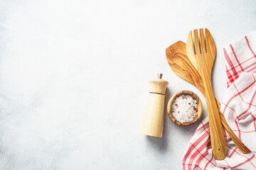Kitchen utensils with herbs spices and tablecloth.