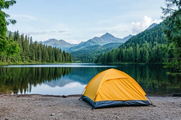 Yellow tent camping by the lake with mountain view in the background