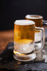 mug of beer on wooden table.
