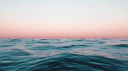 Obraz premium Pastel sunset colors reflecting on calm ocean surface