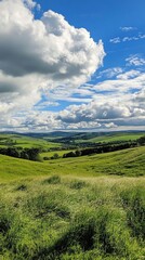 Obraz premium Green Rolling Hills in Landscape with Blue Sky and Clouds