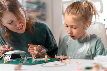 Creative Bonding Wonderful Mother and Child Engaging in Art Exploration Together. Mother and daughter making pendants from uv resin
