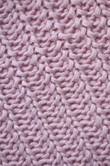 pink texture of knitted wool fabric as a background, purple smooth symmetrical lines of...