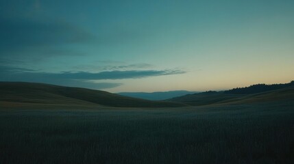 Peaceful serene landscape featuring grassy hills under a blue sky