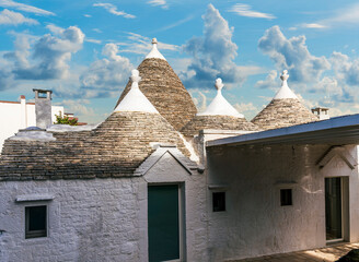 wonderful white mediterranean architecture of italian buildings with sdtrange conic roofs and wfite...