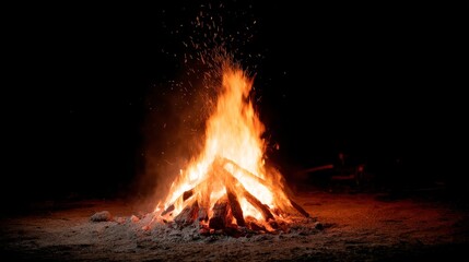 Dynamic orange and red flames rise from a campfire, sending sparks upward in a dark night sky, evoking a sense of warmth and adventure in nature