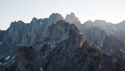  Majestic Mountain Range Under Sunlight: A breathtaking view of a rugged mountain range bathed in the warm, golden light of sunrise or sunset, showcasing the raw power and timeless beauty of nature. 