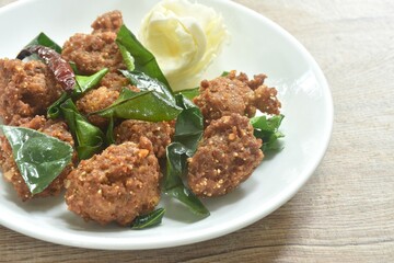 deep fried spicy chop pork ball Thai salad taste spicy and sour with cabbage on plate