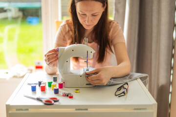 Seamstress working with sewing machine 