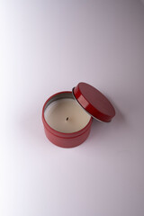 Discover the soothing aroma and gentle flicker of a beautifully scented candle in an elegant red...