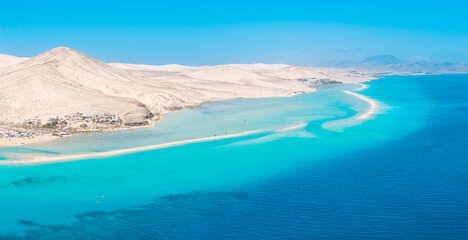 Stunning high aspect aerial panoramic view of the beautiful tropical looking beach, lagoon and sand dunes at Sotavento Risco del Paso beach near Costa Calma on Fuerteventura Canary Islands Spain