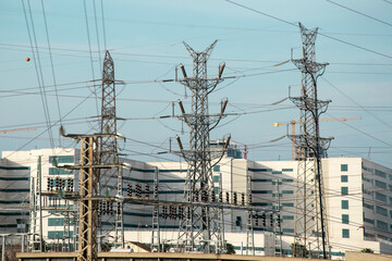 Electrical substation with many metal structures and cables. Management and distribution of electricity in the network. Power shortage. Power outage, blackout, power failure