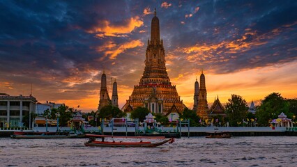 Breathtaking sunset over Wat Arun with vibrant reflections on the Chao Phraya River
