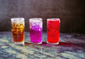 A lot of Soft drinks in colorful and flavorful glasses on the table,Glasses with sweet drinks with ice cubesv