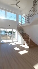 Obraz premium Modern Open Plan Living Room with Wooden Staircase and Large Windows