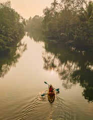 Paddler navigates the tranquil waterways of Chumphon Thailand during golden hour