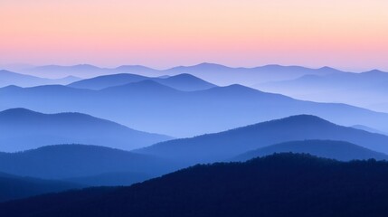 Fototapeta premium Serene layers of blue and violet mountains at sunset