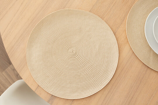 Minimalist aesthetic woven placemat on wooden table