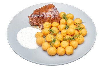 Pork chop with potatoes and sauce. Isolated over white background