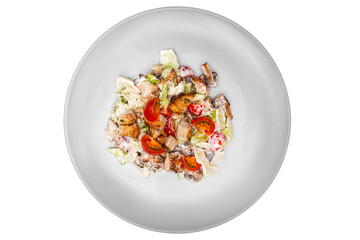 Salad with chicken and vegetables on a plate. Isolated over white background