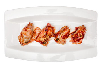 Plate of bacon wrapped prawns. Isolated over white background