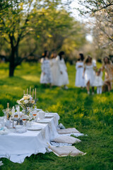A group of people is enjoying a delightful picnic in a lovely park