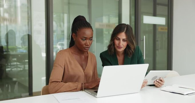 Focused busy diverse business colleagues discussing online product laptop, working together. African project manager woman showing job content on computer to listening colleague, explaining task