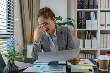 a female employee is feeling very stressed and tired form work, a businesswoman shows signs of...