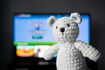 Tv cartoon for kids or family to watch. Television with animated movie, video or game for child. Toy teddy bear. Series streaming service for children. Home technology and screen time limit concept.