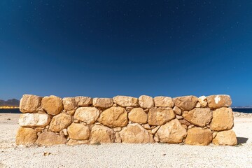 A serene black landscape at night featuring a small stone composition, perfect for artistic and atmospheric visuals.