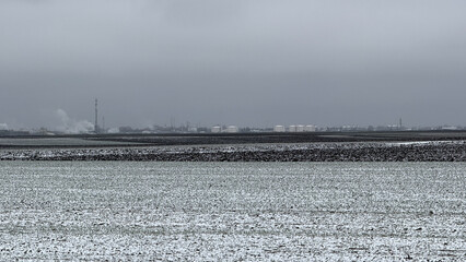 Snow-dusted rural landscape under overcast sky, serene winter, tranquil countryside, cozy indoors,...