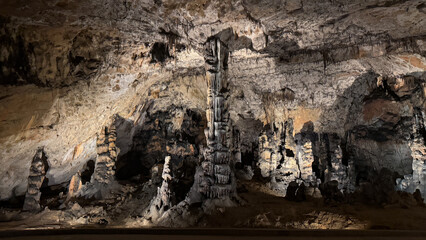 Stunning limestone stalactites in an illuminated cave, adventure exploration, natural wonders,...