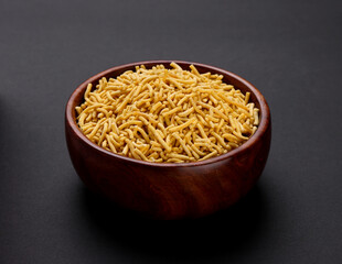 Indian popular snacks called Sev or Medium Sev isolated on black background 