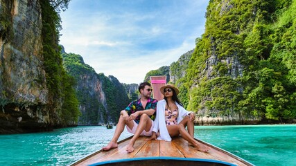 Couple enjoying a romantic moment on a longtail boat in Koh Phi Phis stunning lagoon