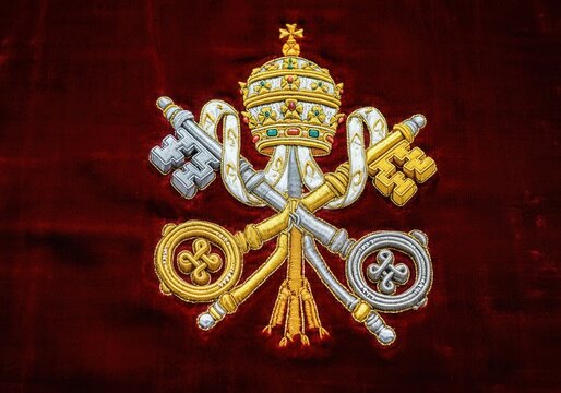 Embroidered Vatican insignia with papal tiara and crossed keys on velvet background