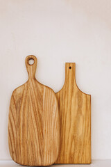 Natural wooden cutting boards displayed against a neutral background