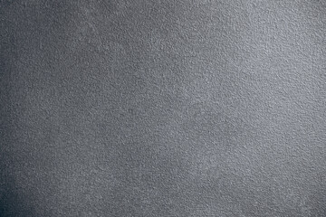 Surface texture of a gray material with subtle patterns and design elements in natural light